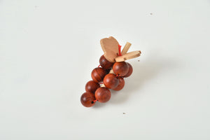 Wooden play food set for kids' kitchen, showcasing colorful pieces at an angle for indoor playtime fun.