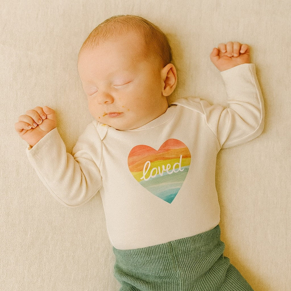 Long sleeve graphic bodysuit featuring a loved rainbow heart design for babies.