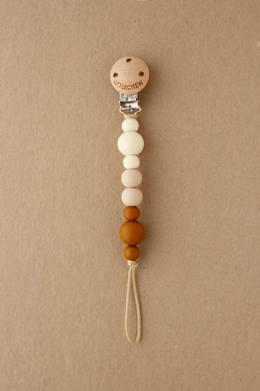 Pacifier Clip - Kira in Clay color, stylish and functional for keeping pacifiers close to your baby.