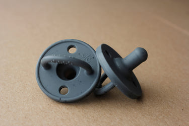 Speckled charcoal silicone pacifier for babies, designed for comfort and safety.