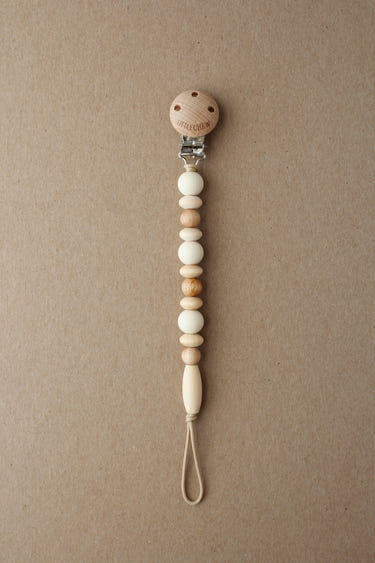 Cream Omar Pacifier Clip for babies, stylish and functional accessory to keep pacifiers within reach.