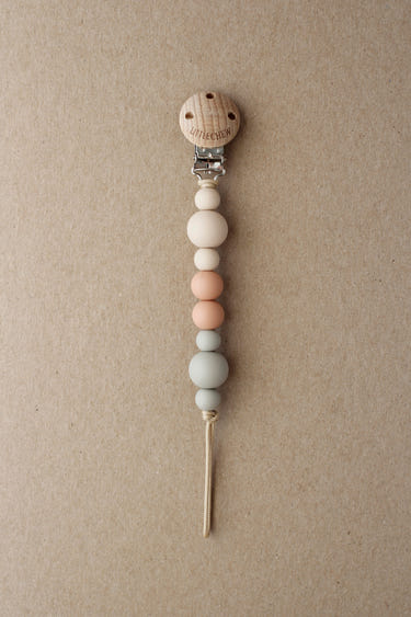 Pacifier Clip - Kira in Pale color, perfect for keeping pacifiers secure and stylish for your baby.
