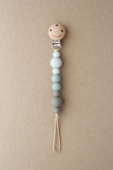 Grey Kira Pacifier Clip for babies, stylish and functional accessory to keep pacifiers within reach.