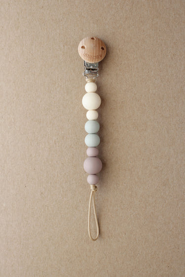 Pacifier Clip - Kira in Dusty color, stylish and functional for keeping pacifiers close to your baby.