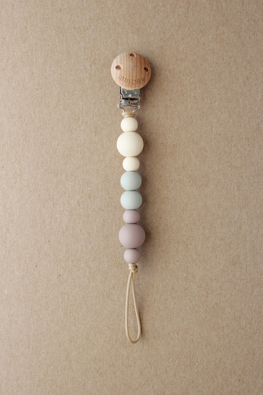 Pacifier Clip - Kira in Dusty color, stylish and functional for keeping pacifiers close to your baby.