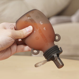Haakaa Happii Bear Silicone Goody Pouch 6 oz in angle view, perfect for baby feeding and on-the-go convenience.