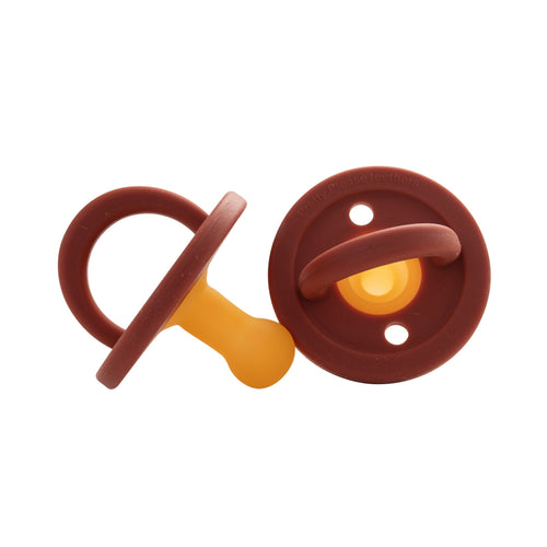 Modern Red Rock pacifier for babies, featuring a sleek design and safe materials. Perfect for soothing infants.