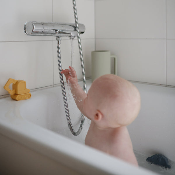 Colorful bath rinse cup for babies, angled view showcasing ergonomic design and easy grip for bath time fun.