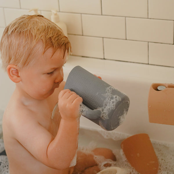 Colorful bath rinse cup for babies, designed for easy rinsing at bath time, shown from angle 21.