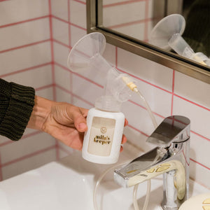 Set of 2 glass breast milk bottles at a 15-degree angle for safe and stylish milk storage.