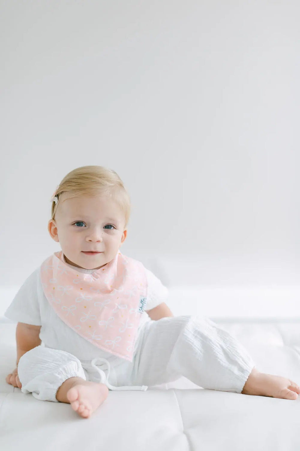 Colorful bandana bibs featuring flowers, hearts, and bows for stylish baby feeding and drooling protection.