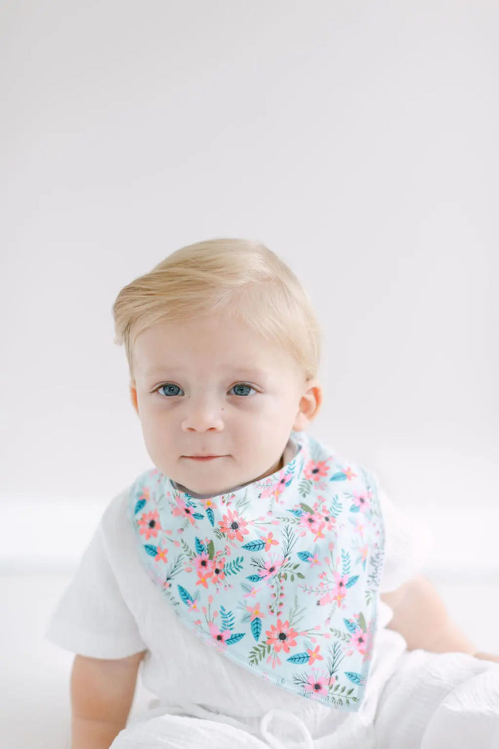 "Shore Set bandana bibs for babies featuring anchors, flowers, flamingos, and boats in vibrant colors."