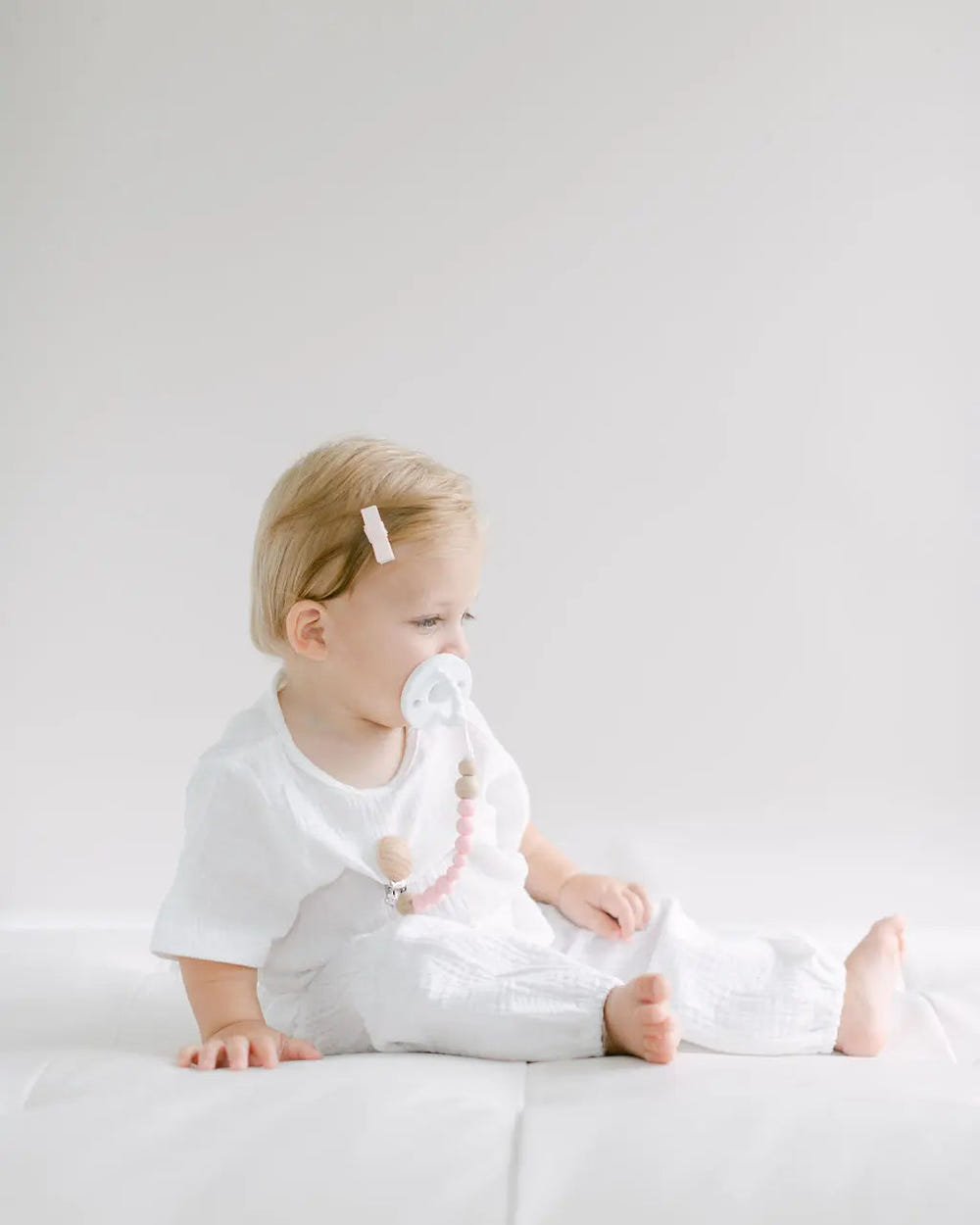 Pink pacifier clip for babies, ensuring pacifier stays clean and within reach. Perfect for stylish and practical use.