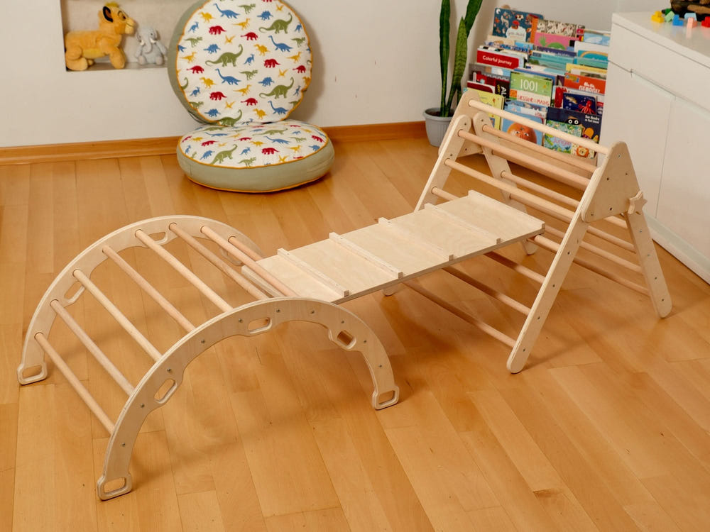 Montessori indoor playground with Pikler triangle, climbing arch, 2-in-1 ramp, and pillow for active baby play.