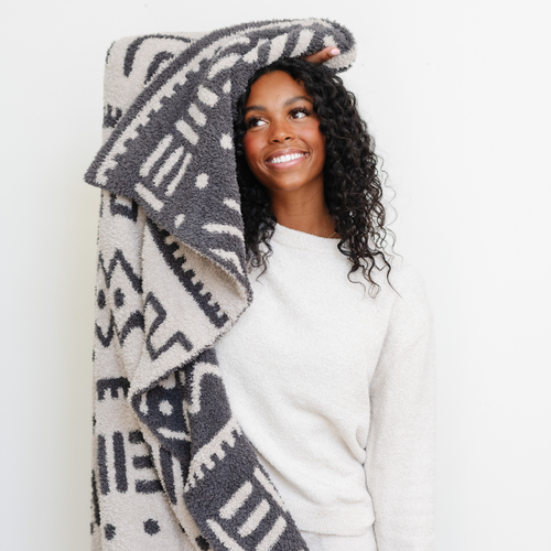 Double-layer Bamboni® throw blanket for babies, soft and cozy, perfect for swaddling and keeping warm. Angle view.