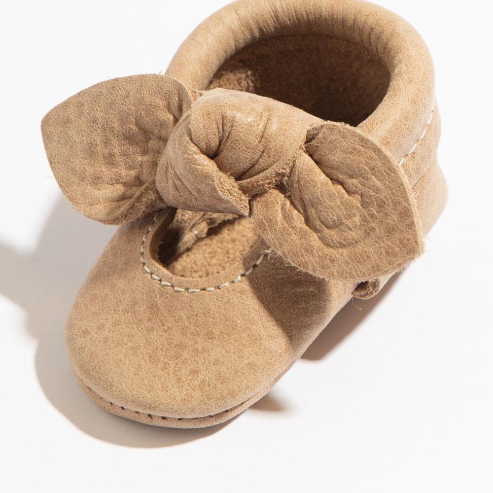 Newborn weathered brown knotted bow baby shoe, perfect for stylish little feet.