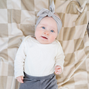 Minky stretch receiving blankets in soft colors, perfect for swaddling and keeping babies cozy.