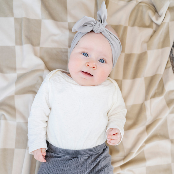 Minky stretch receiving blankets in soft colors, perfect for swaddling and keeping babies cozy.