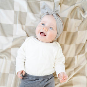 Minky stretch receiving blankets in soft colors, perfect for swaddling and keeping your baby cozy. Angle 3 view.