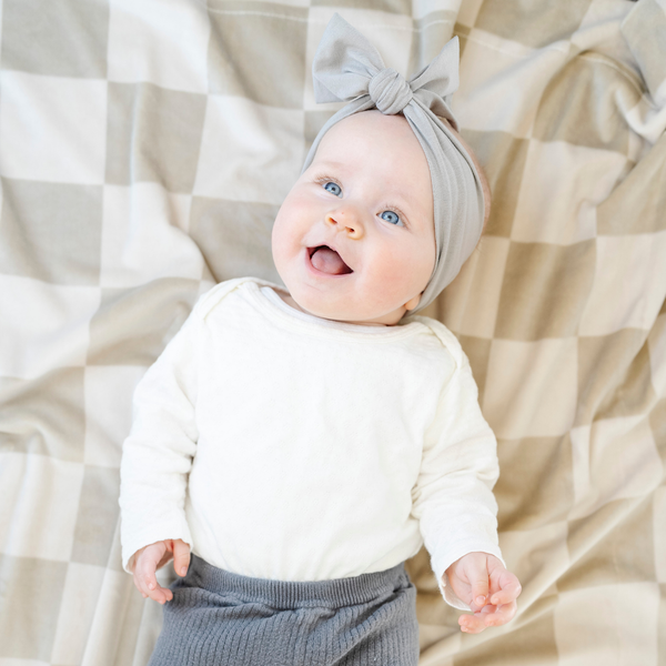 Minky stretch receiving blankets in soft colors, perfect for swaddling and keeping your baby cozy. Angle 3 view.