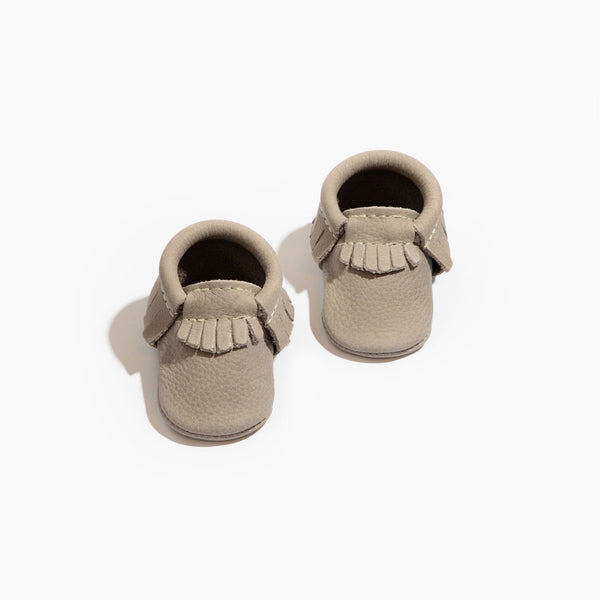 Newborn Salt Flats Moccasin Baby Shoe in soft beige, perfect for stylish and comfortable infant footwear.