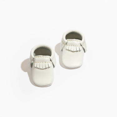 Newborn bright white moccasin baby shoe, perfect for stylish and comfortable baby footwear.