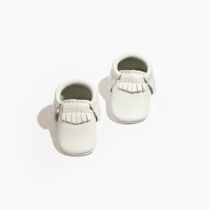 Newborn bright white moccasin baby shoe, perfect for stylish and comfortable baby footwear.