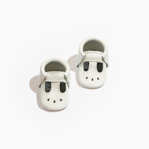Newborn bright white Mary Jane baby shoes, perfect for stylish little feet.
