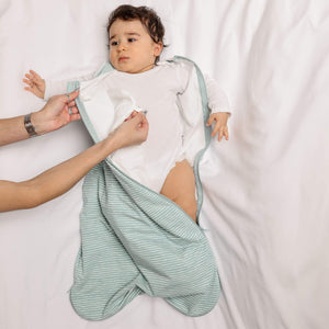 One & Done Sleep Sack in green stripes, angle view showcasing cozy design for baby sleep safety and comfort.