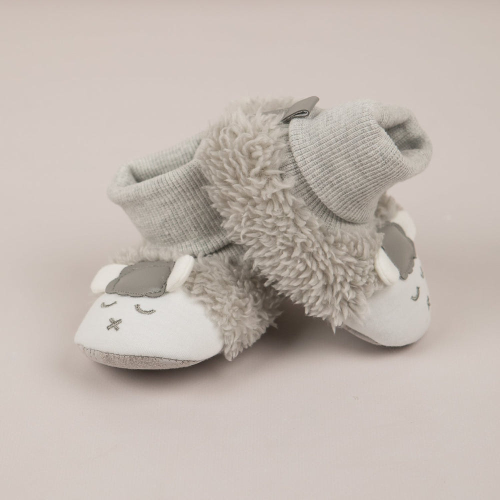 Soft "Baby's First" lamb booties for infants, perfect for cozy comfort and adorable style.
