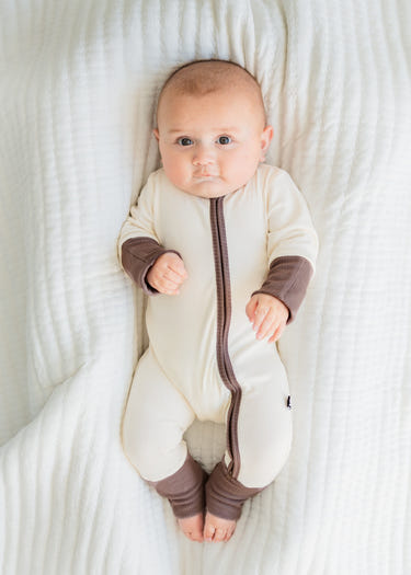 Oatmeal ribbed romper for babies, soft and stylish, perfect for everyday wear.