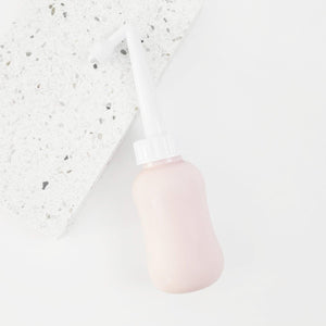 "Peri bottle for postpartum wellness, angled view showcasing ergonomic design and easy grip for comfort."
