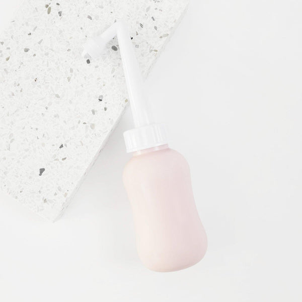 "Peri bottle for postpartum wellness, angled view showcasing ergonomic design and easy grip for comfort."