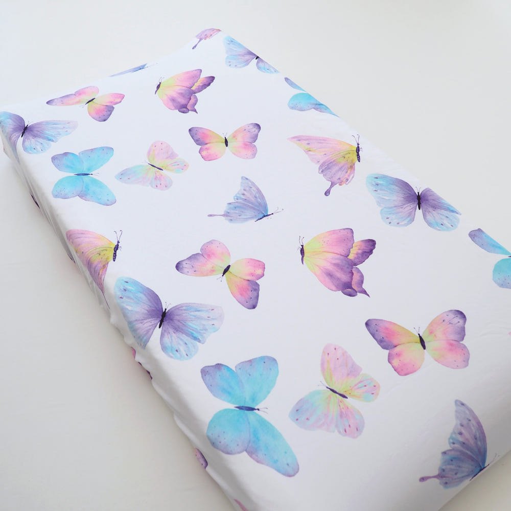 Butterfly changing pad cover for baby, soft and stylish, perfect for nursery decor and diaper changes.