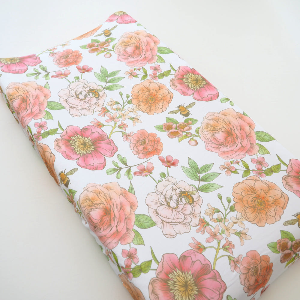 Botanical floral changing pad cover for babies, perfect for nursery decor and comfort during diaper changes.