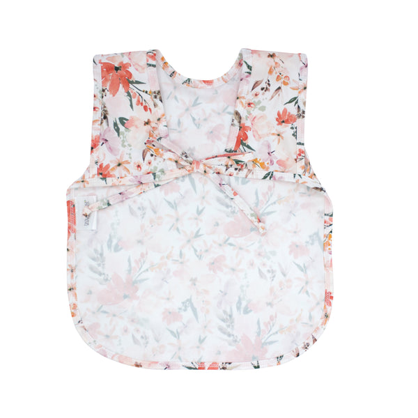 Peachy Dreams Bapron for babies, angle view showcasing its soft fabric and vibrant peach design.