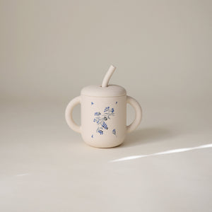 Silicone training cup with straw, designed for easy sipping, perfect for toddlers transitioning from bottles.