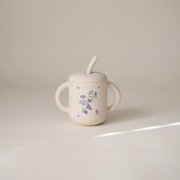 Silicone training cup with straw, designed for easy sipping, perfect for toddlers transitioning from bottles.