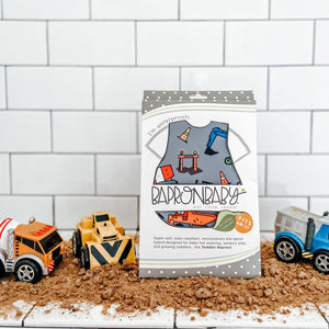 "Construction Zone Bapron for babies, featuring vibrant colors and fun design, angled view showcasing its unique style."