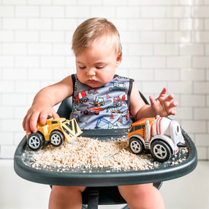 "Construction Zone Bapron for babies, featuring colorful construction designs, perfect for mess-free mealtime."