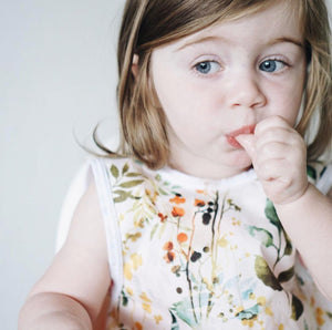 "Autumn Leaves Bapron for babies, featuring a vibrant leaf design, angled view showcasing its stylish and functional design."