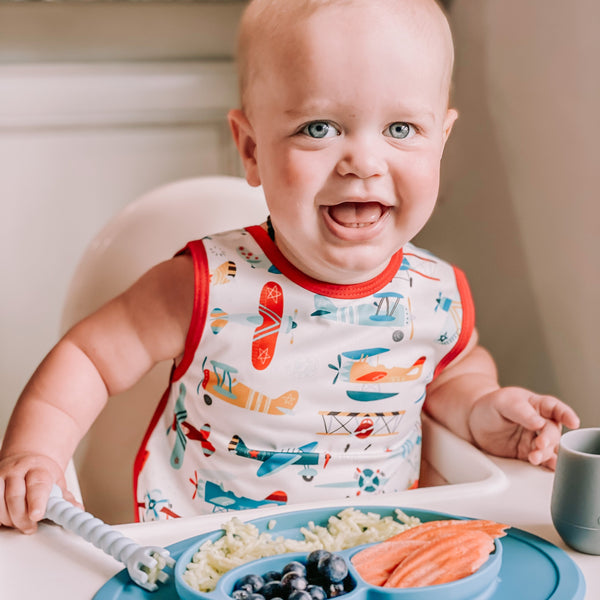 Retro Airplanes Bapron for babies, angle view showcasing playful design and practical use for mealtime messes.