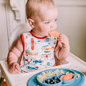 Retro Airplanes Bapron for babies, featuring a fun design and comfortable fit, angled view showcasing its vibrant colors.