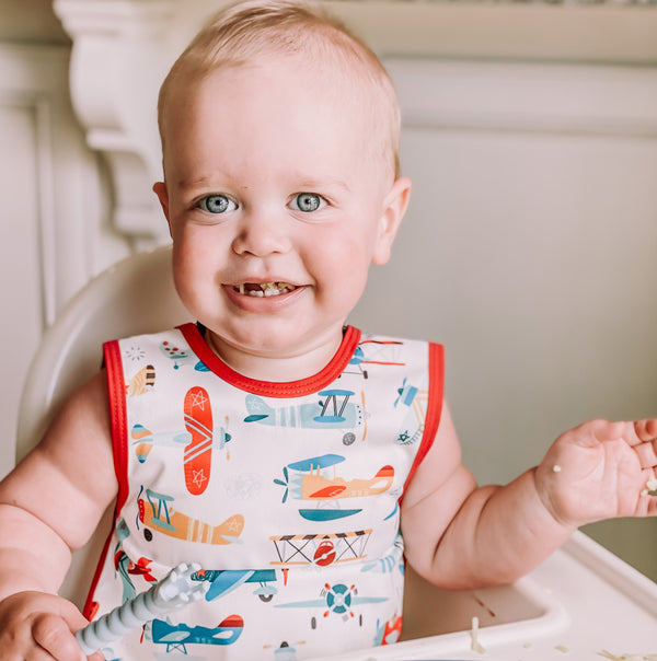 Retro Airplanes Bapron for babies, angled view showcasing playful design and practical features for mealtime messes.