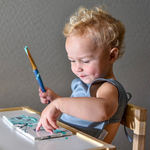 Solid Slate Minimalist Bapron for babies, shown at angle 7, featuring a sleek design and practical functionality.