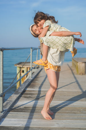 Oversized organic cotton t-shirt in fern plaid for babies, shown from angle 3.