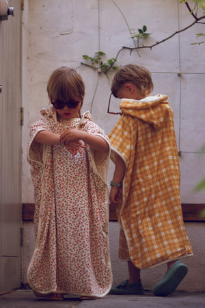 Organic cotton bathing towel poncho for babies in Sunset Meadow design, angle view 4. Perfect for bath time!