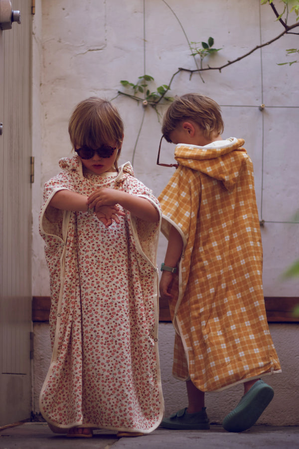 Organic cotton bathing towel poncho for babies in Sunset Meadow design, angle view 4. Perfect for bath time!