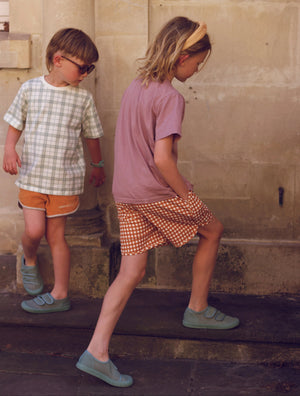 Oversized organic cotton t-shirt in fern plaid for babies, angle view showcasing soft fabric and stylish design.