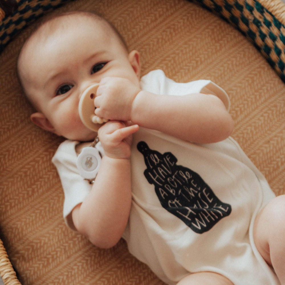 White graphic short sleeve bodysuit for babies, featuring a cute house design. Perfect for everyday wear.